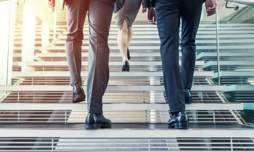 Business persons going up the stairs.